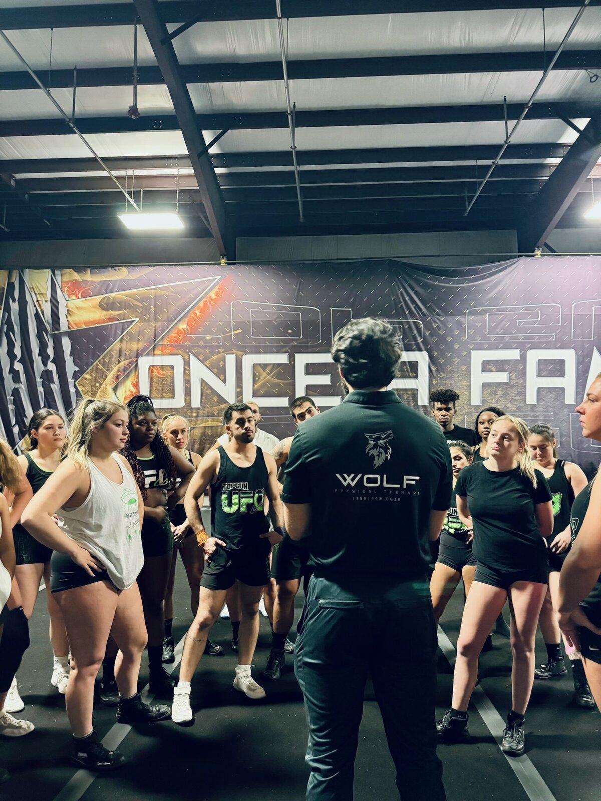 Wolf Performance & Recovery PT addressing a cheer team